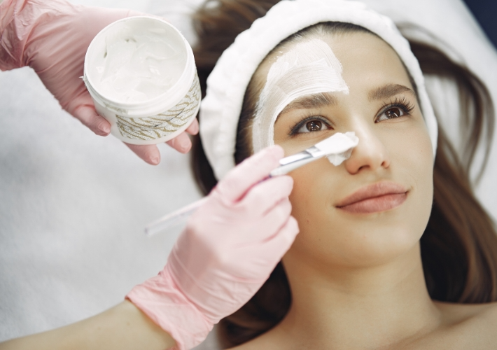 Esthetician is Doing Facial on Young Woman Face