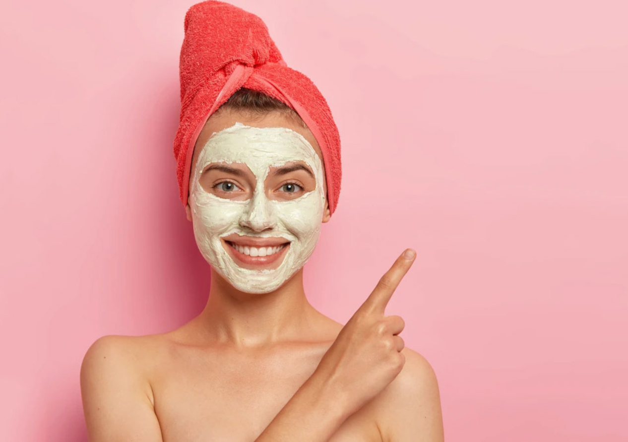 A Young Girl Wearing Towel on her Head and Applying Facial Mask