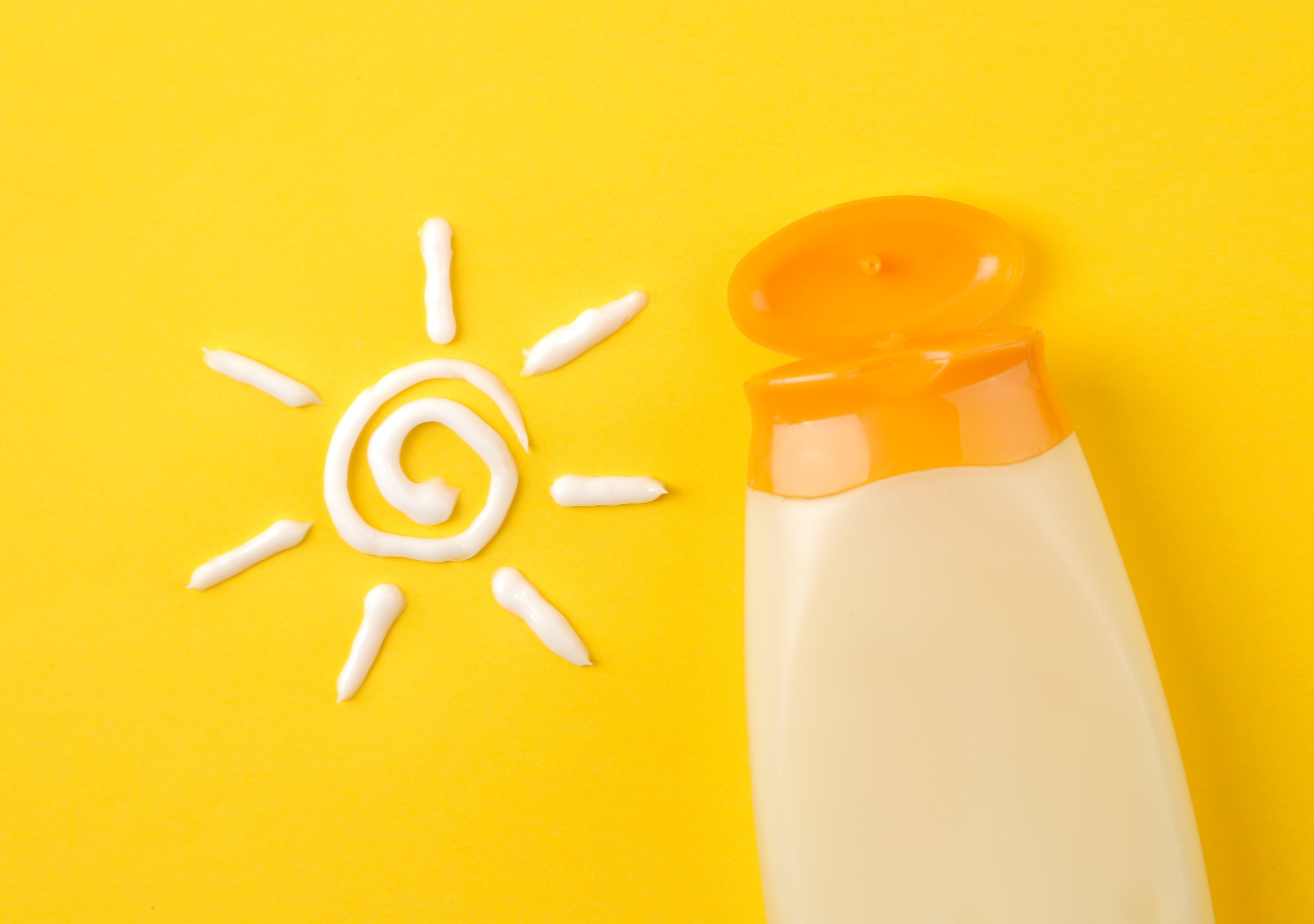 A Sunscreen with a Sun Image Made by Cream Next to it