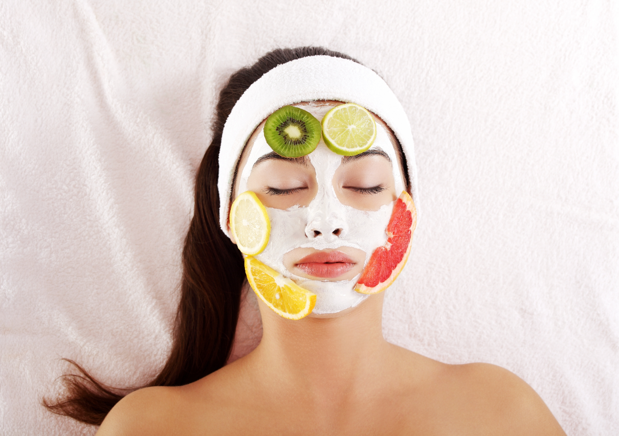 Young Woman with Handmade Facial Mask and Some Fruit Slices on her Face