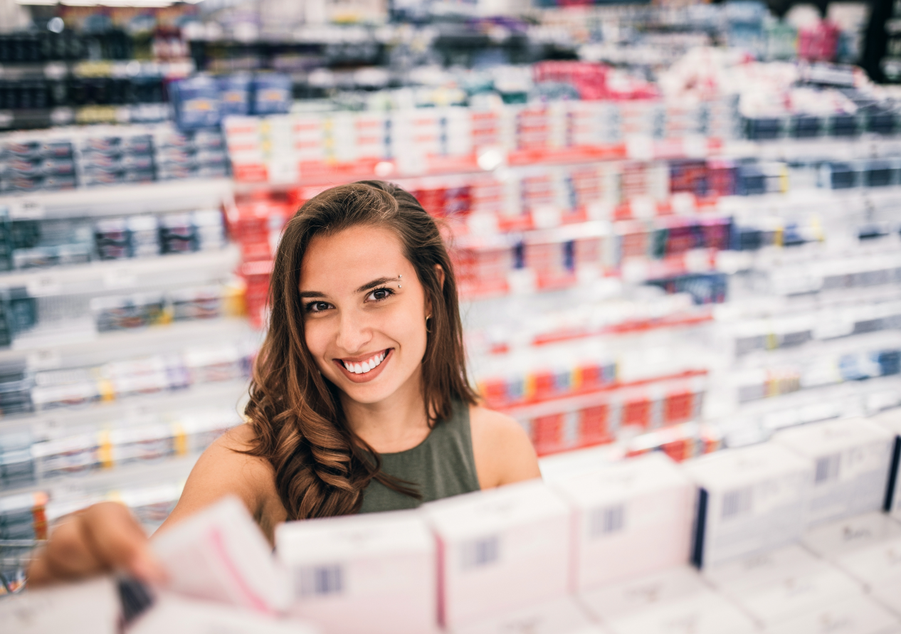 Smiling Young Woman in the Market Looking at the Camera