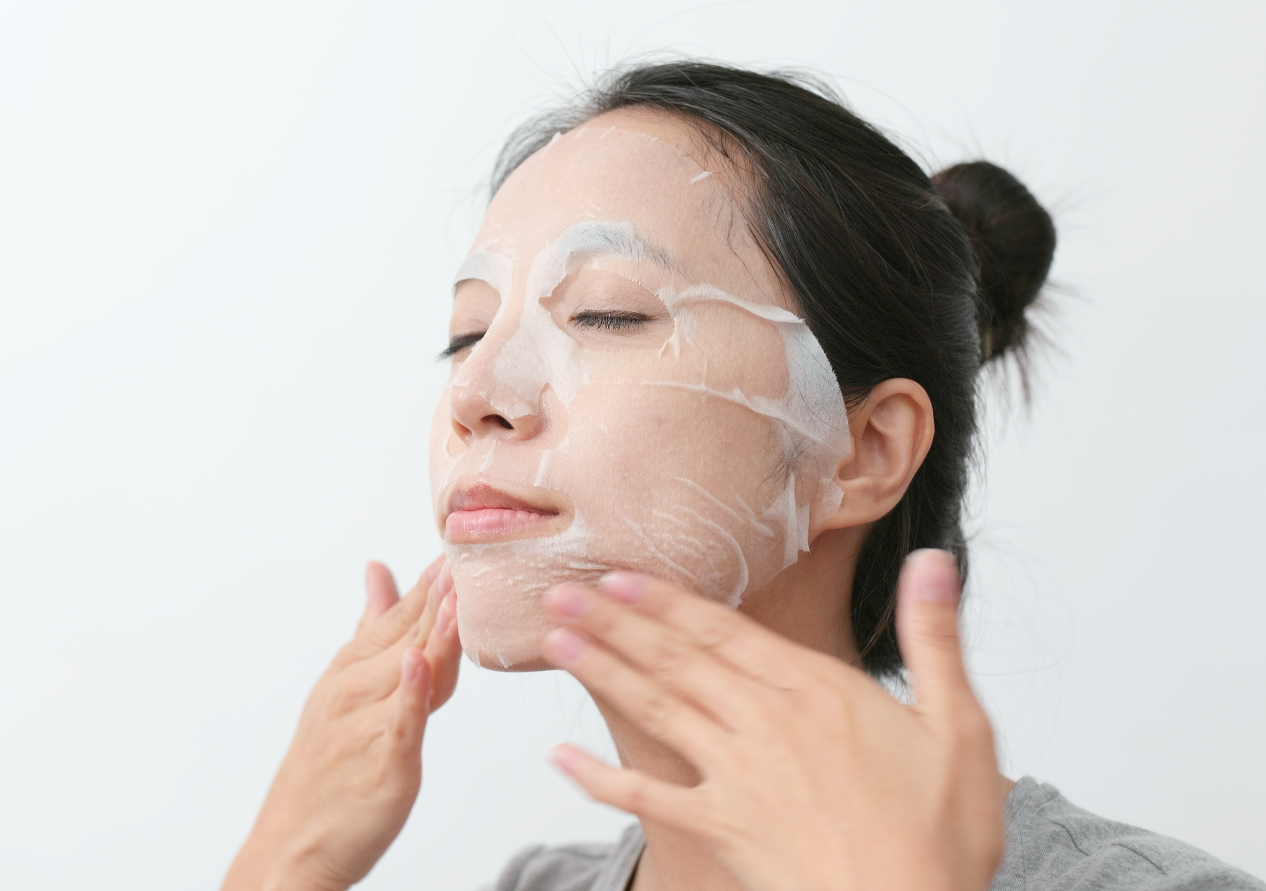 Asian Girl is Applying Paper Sheet Mask on her Face