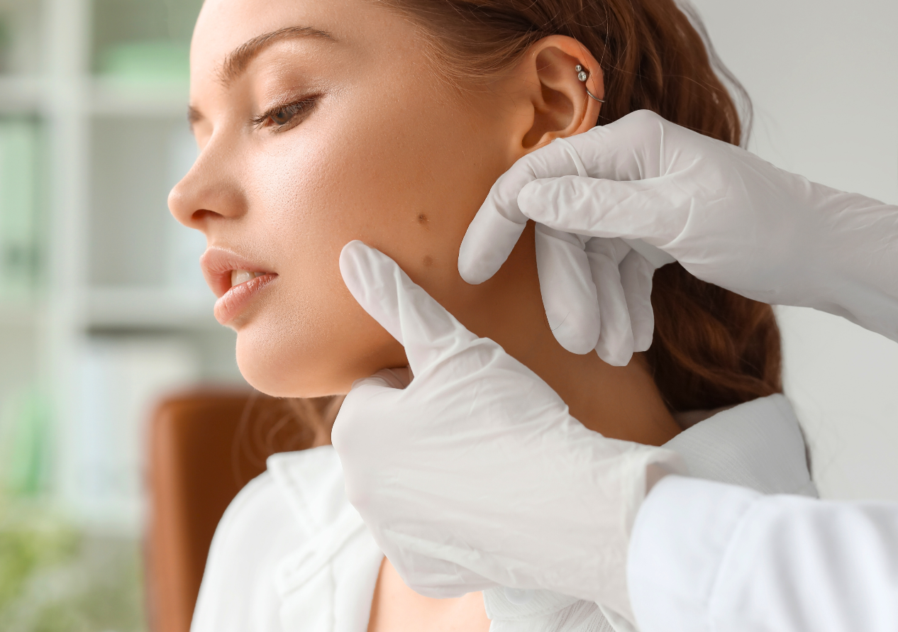 Dermatologist Hands are Touching a Young Woman's Face