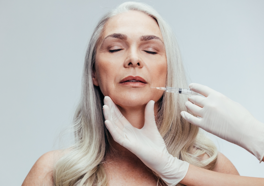 Dermatologist is Injecting on the Middle-Aged Woman's Face