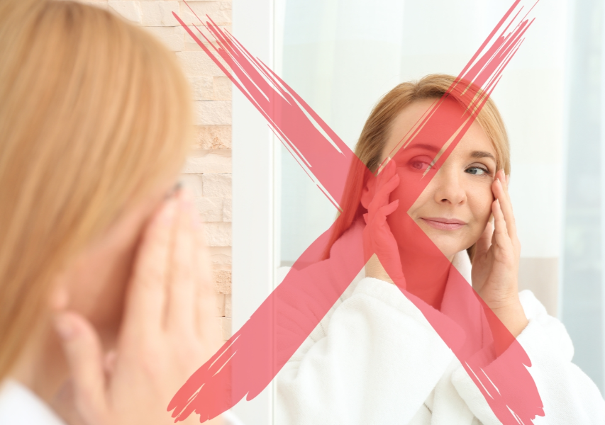 A Red Cross on the Image of a Woman Looking at Mirror