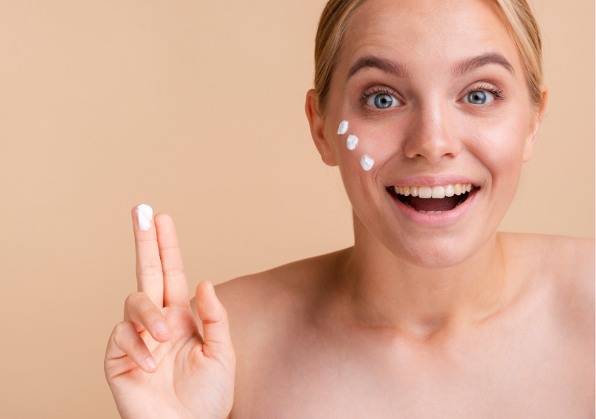 Smiling Young Woman Rubbing Some Cream on Face