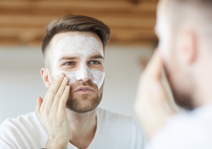 Young Man with Scrub Mask in Front of the Mirror