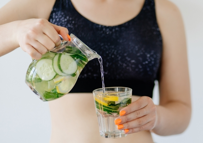 Woman is Pouring Detox Water in Glass