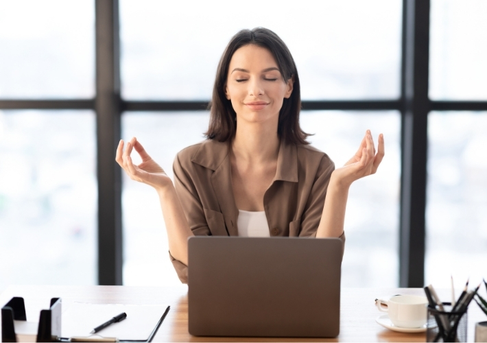 Young Woman Sitting in Yoga Posture at Office