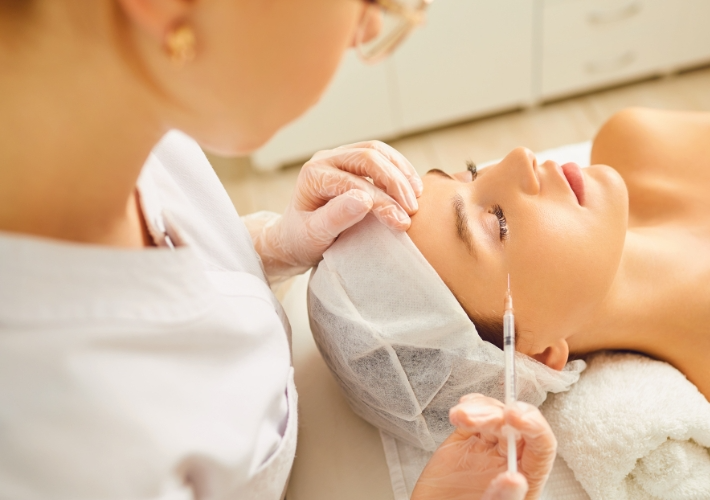 Female Dermatologist is Doing Injection under Eyes of Patient